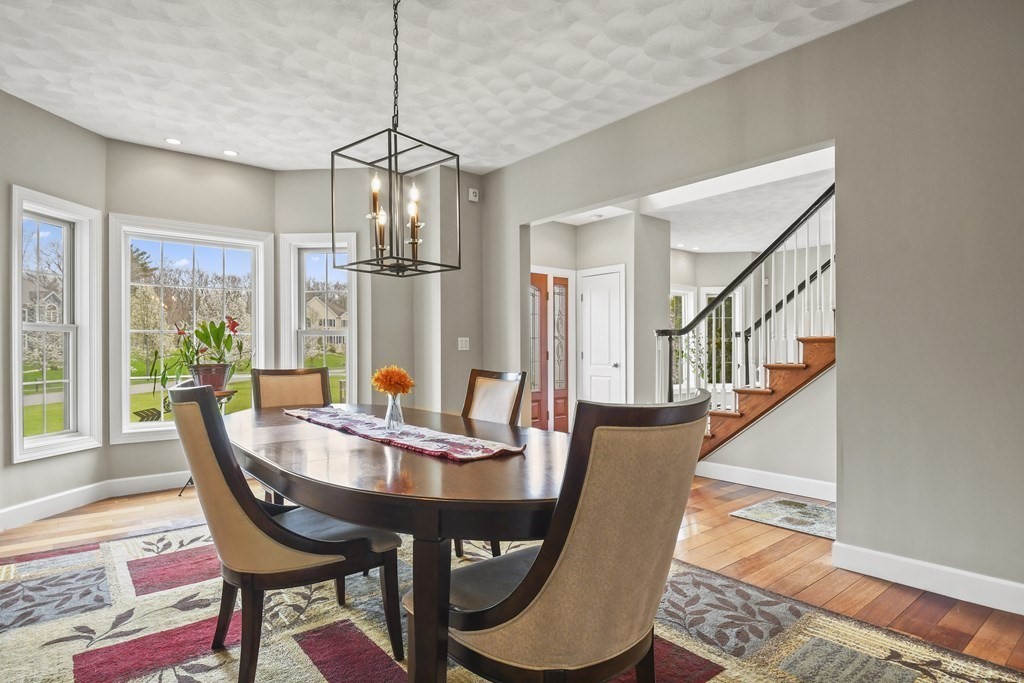 25 Wilkes Road Rowley, MA 01969 - Photo 6 of 40 a dining room with furniture a chandelier and wooden floor
