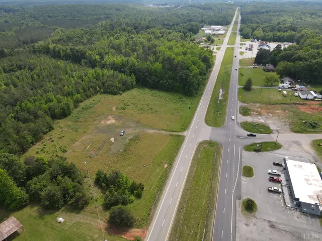 a view of swimming pool with a garden and trees