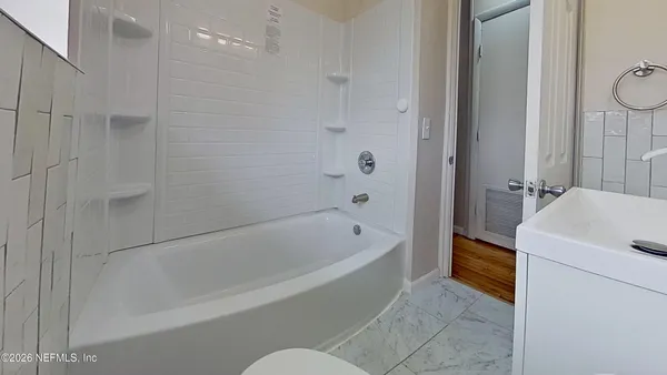 a bathroom with a bathtub and a shower