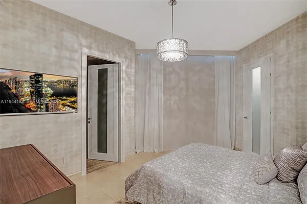a bedroom with a large bed and a tv