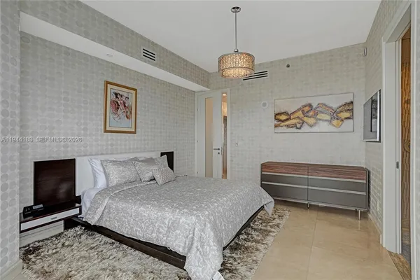 a bathroom with a granite countertop sink a toilet a mirror and shower