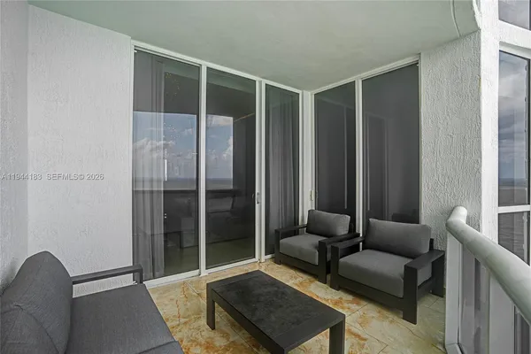 a living room with furniture a chandelier and a flat screen tv