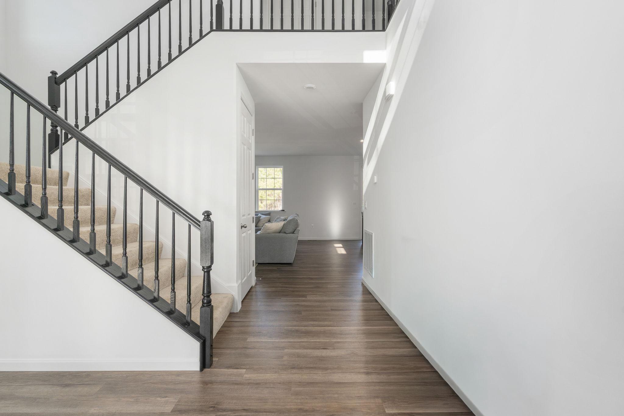 6371 Pointer Lane King George, VA 22485 - Photo 6 of 38 a view of a hallway with wooden floor and staircase