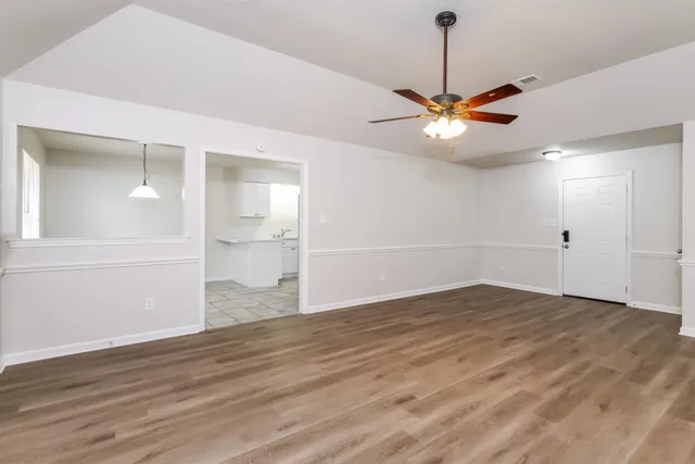 a view of a house with a yard and tree s