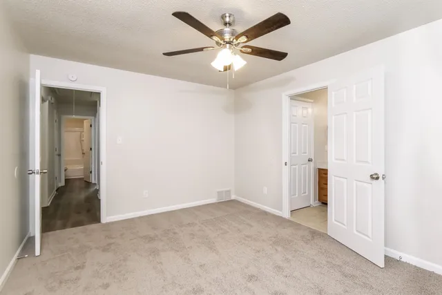 a kitchen with a sink a refrigerator and cabinets