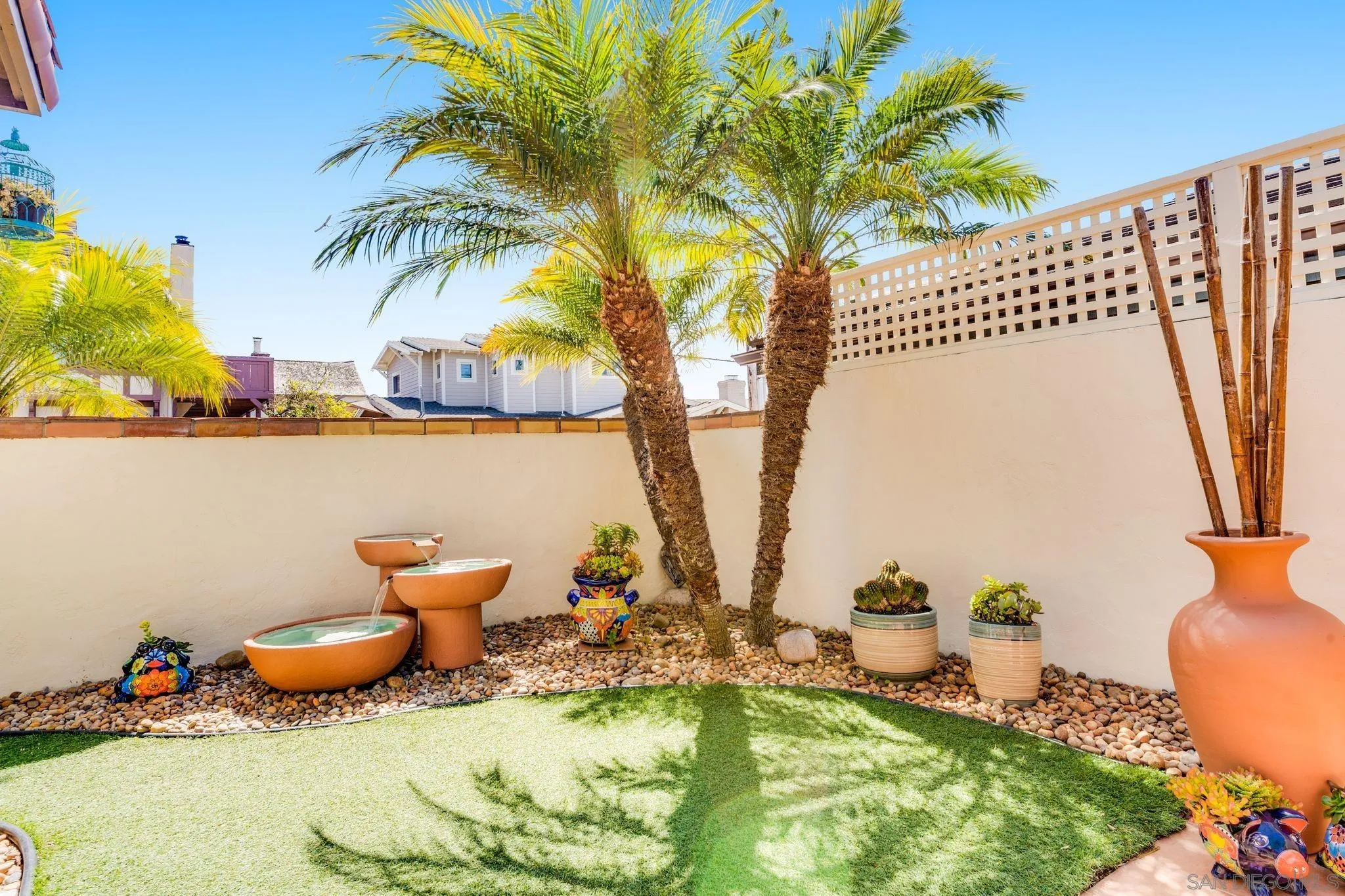818 Genter Street La Jolla, CA 92037 - Photo 14 of 26 a backyard of a house with table and chairs