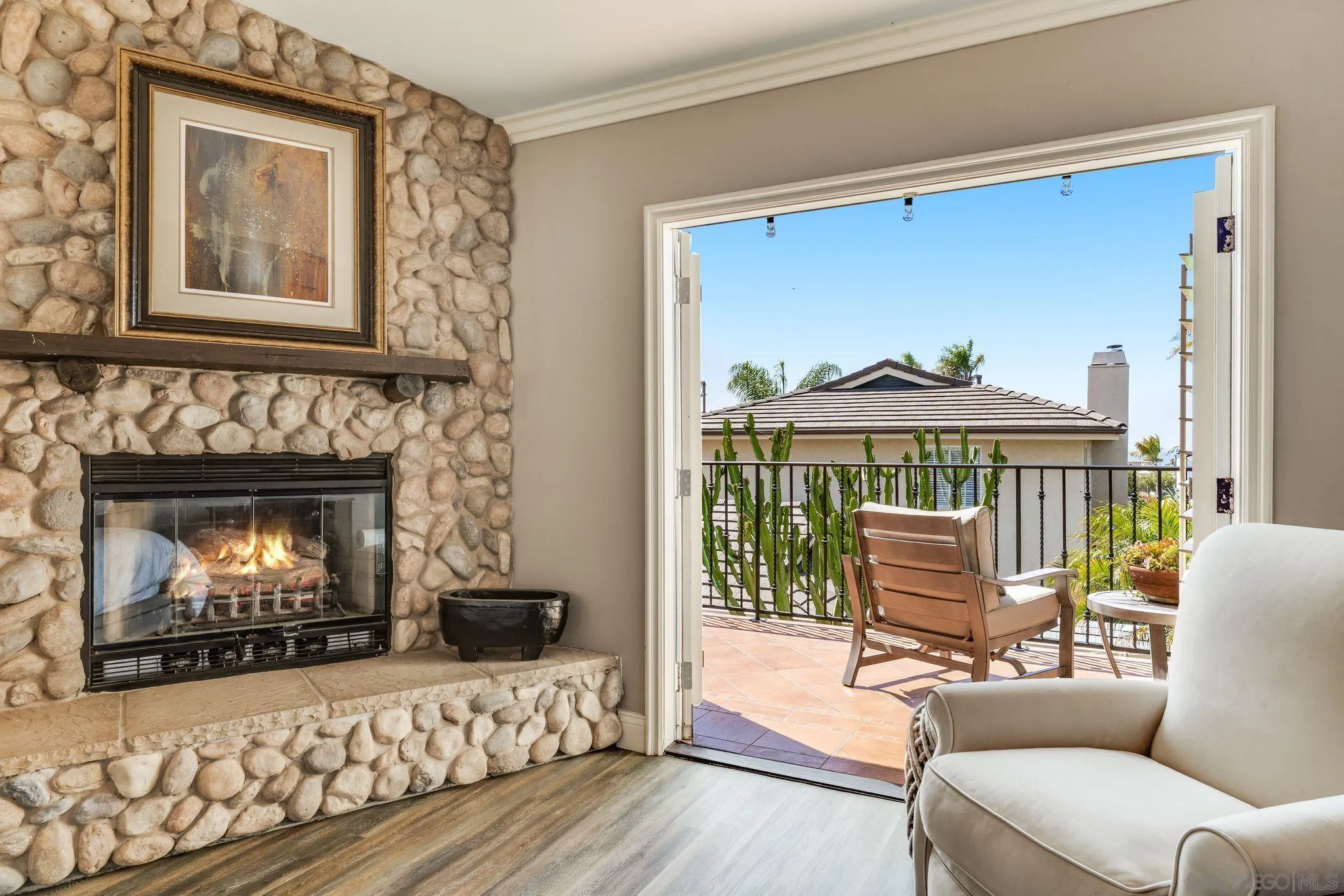 818 Genter Street La Jolla, CA 92037 - Photo 18 of 26 a living room with furniture a flat screen tv and a fireplace
