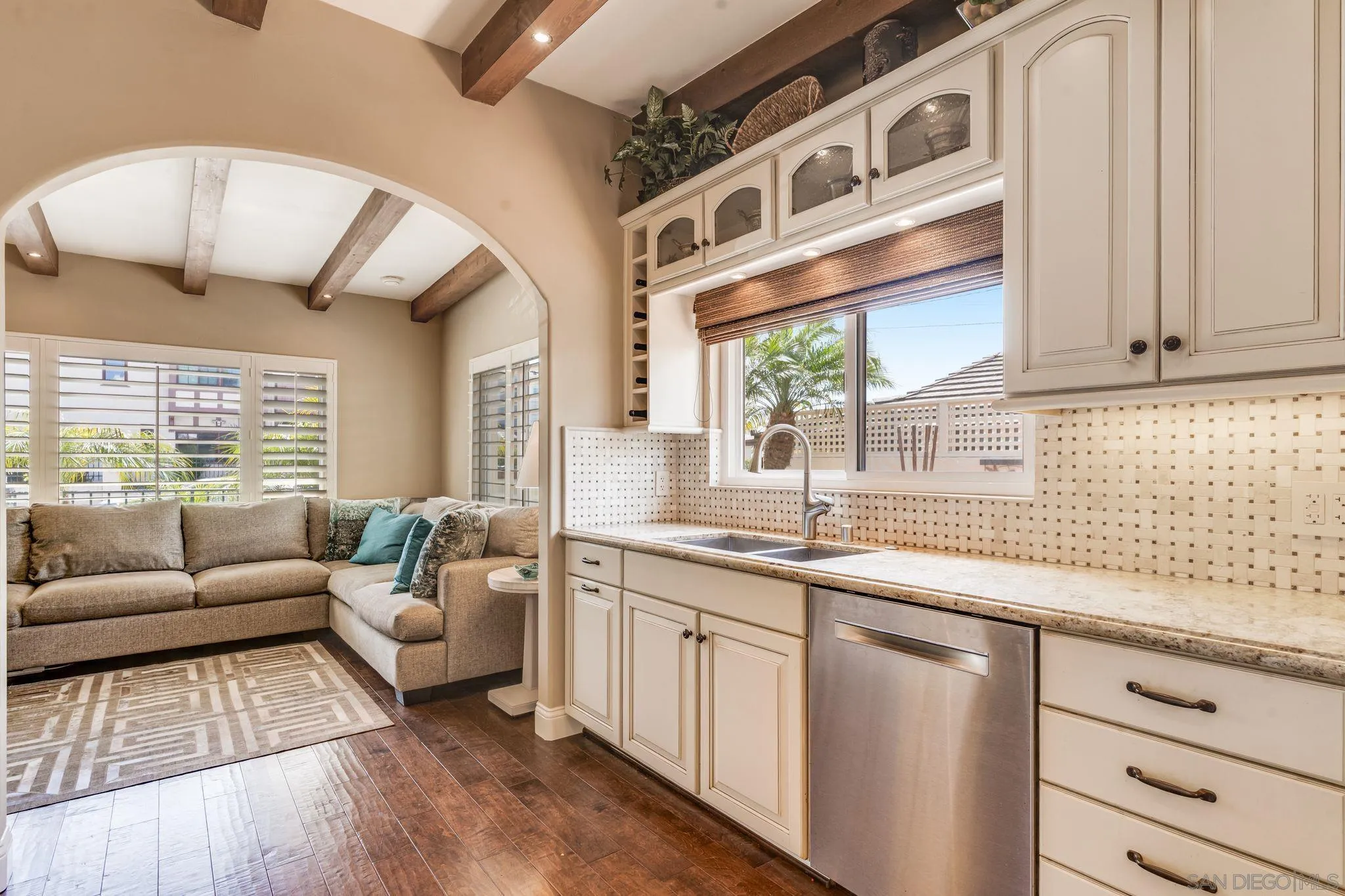 818 Genter Street La Jolla, CA 92037 - Photo 4 of 26 a kitchen with stainless steel appliances granite countertop a sink and dishwasher with wooden floor