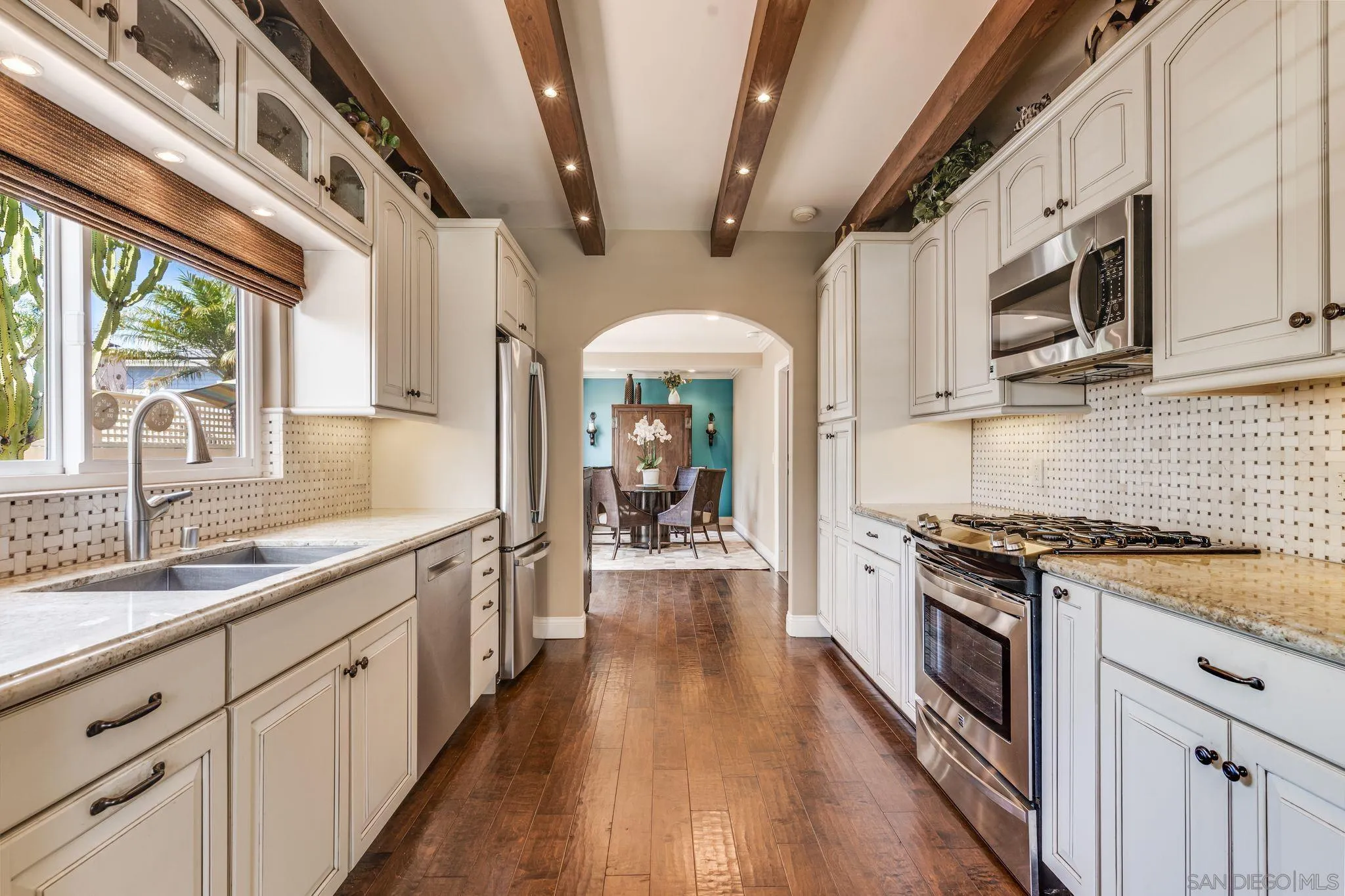 818 Genter Street La Jolla, CA 92037 - Photo 6 of 26 a large kitchen with stainless steel appliances granite countertop a lot of counter space and wooden floors