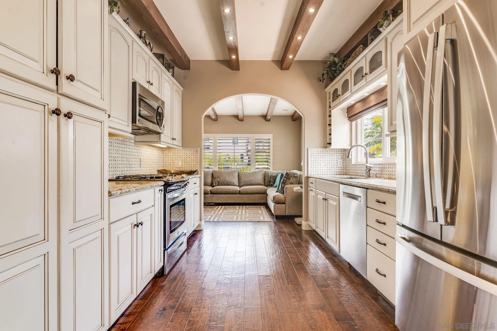 818 Genter Street La Jolla, CA 92037 - Photo 8 of 26 a kitchen with stainless steel appliances a white cabinets and a large window