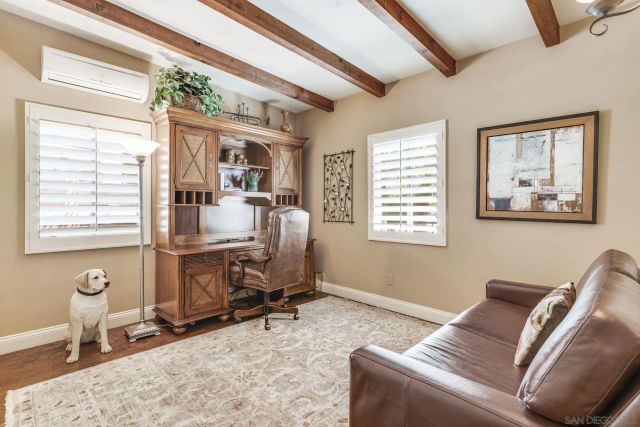a view of a livingroom with workspace and a window