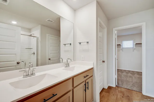 a bathroom with a sink double vanity and a mirror