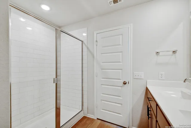 a bathroom with a shower and a sink