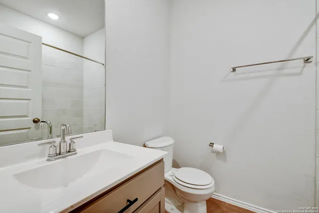 a bathroom with a sink toilet and vanity