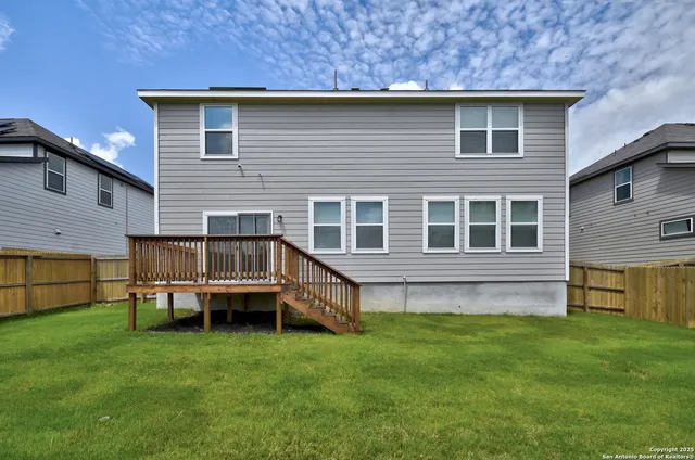 a view of a house with a yard and deck