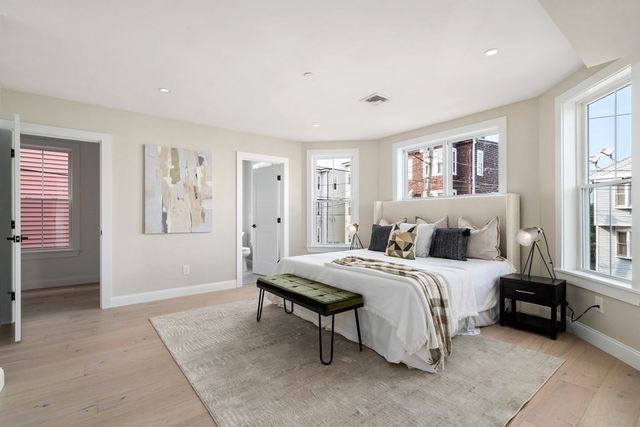 a spacious bedroom with a bed and a window