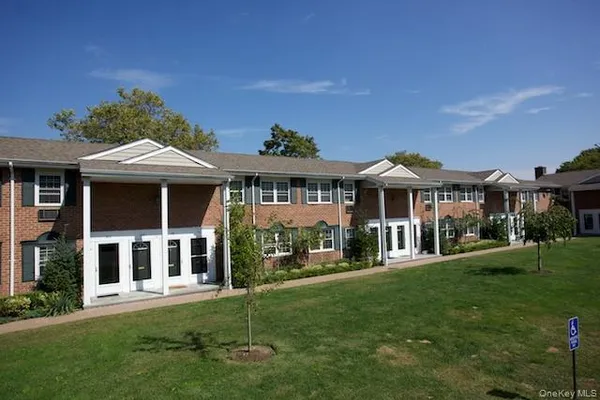 a front view of a residential apartment building with a yard