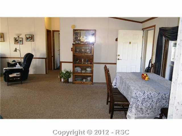 19117 Murphy Road Peyton, CO 80831 - Photo 10 of 16 Dining room foreground - Living Room background