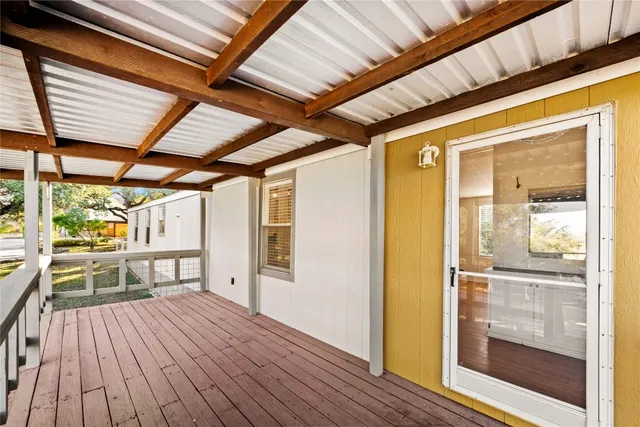 a view of a porch with wooden floor and outdoor space