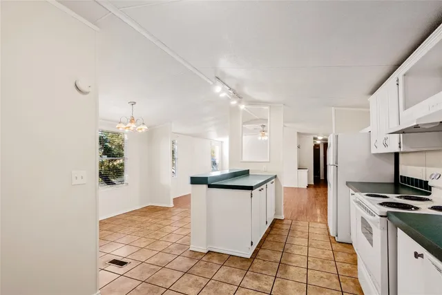 a kitchen with stainless steel appliances granite countertop a refrigerator and a stove