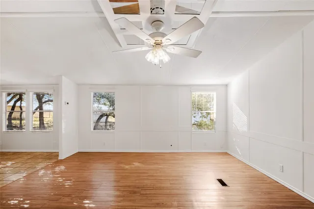 wooden floor in an empty room with a window