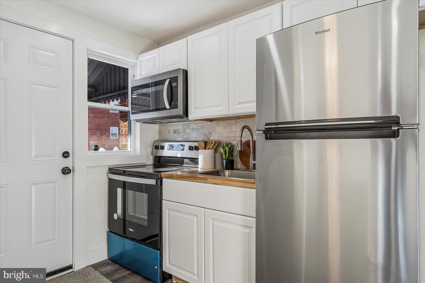 3925 Chesterfield Avenue Baltimore, MD 21213 - Photo 14 of 35 a kitchen with stainless steel appliances a refrigerator and cabinets