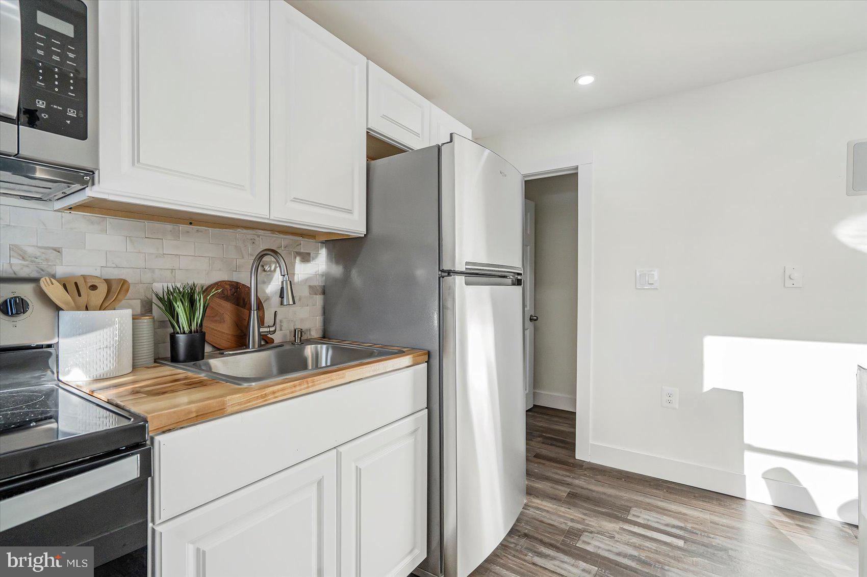 3925 Chesterfield Avenue Baltimore, MD 21213 - Photo 15 of 35 a kitchen with stainless steel appliances granite countertop a refrigerator and a sink