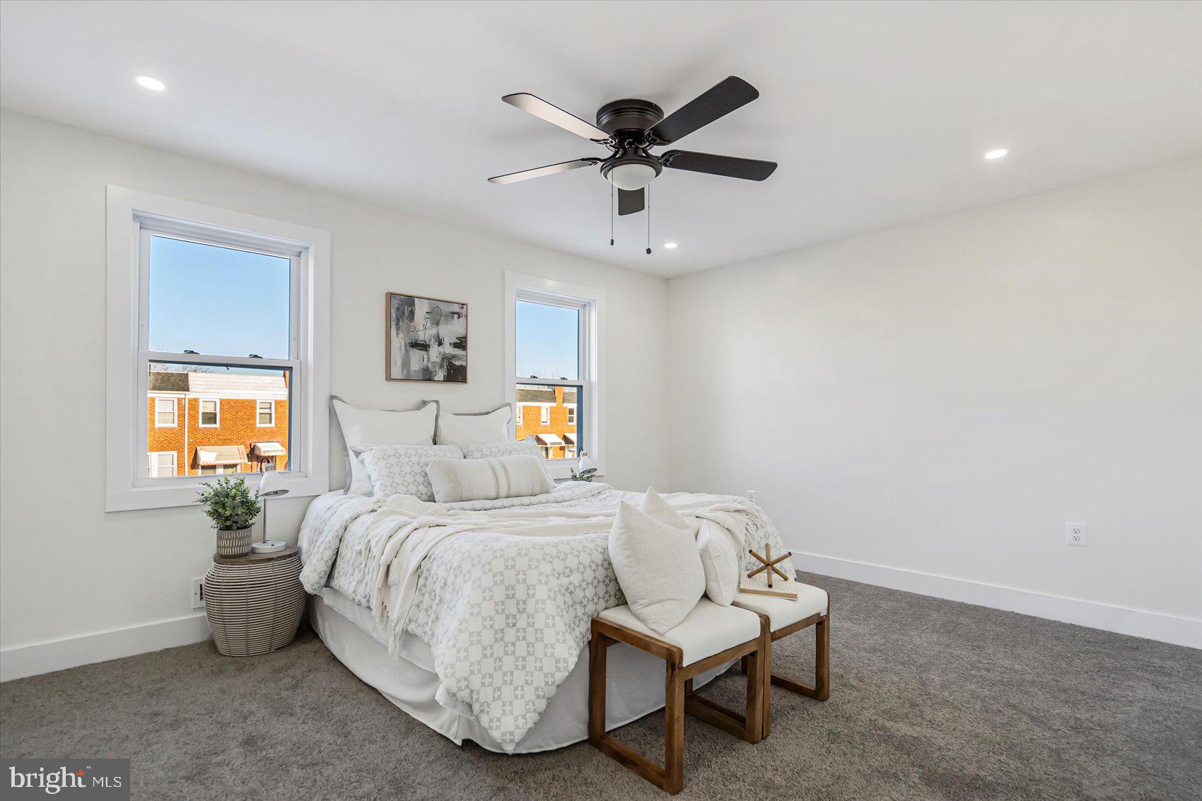 3925 Chesterfield Avenue Baltimore, MD 21213 - Photo 21 of 35 a bedroom with a bed and a chandelier