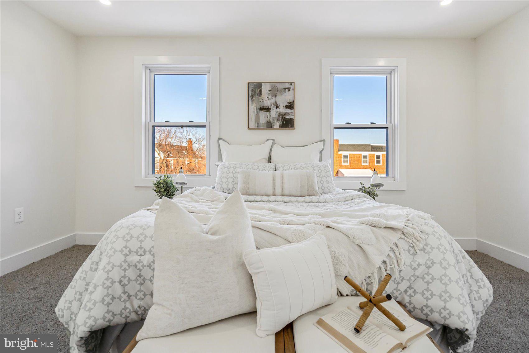 3925 Chesterfield Avenue Baltimore, MD 21213 - Photo 22 of 35 a spacious bedroom with a bed and a window