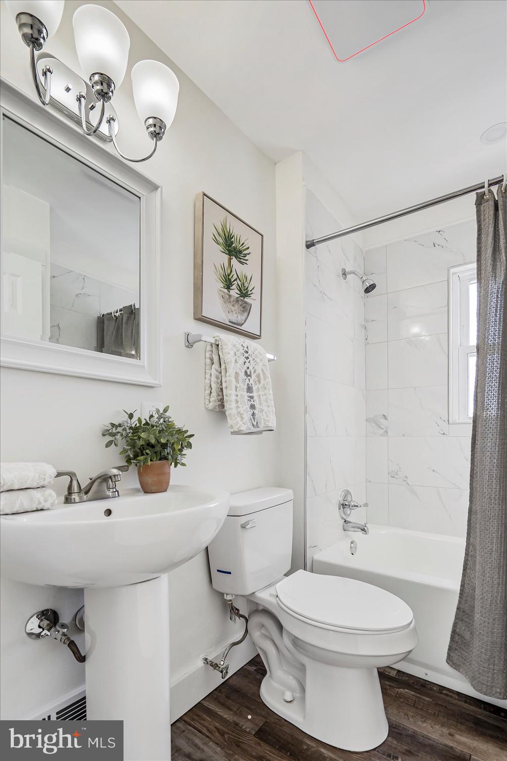 3925 Chesterfield Avenue Baltimore, MD 21213 - Photo 25 of 35 a bathroom with a sink a toilet a mirror and shower