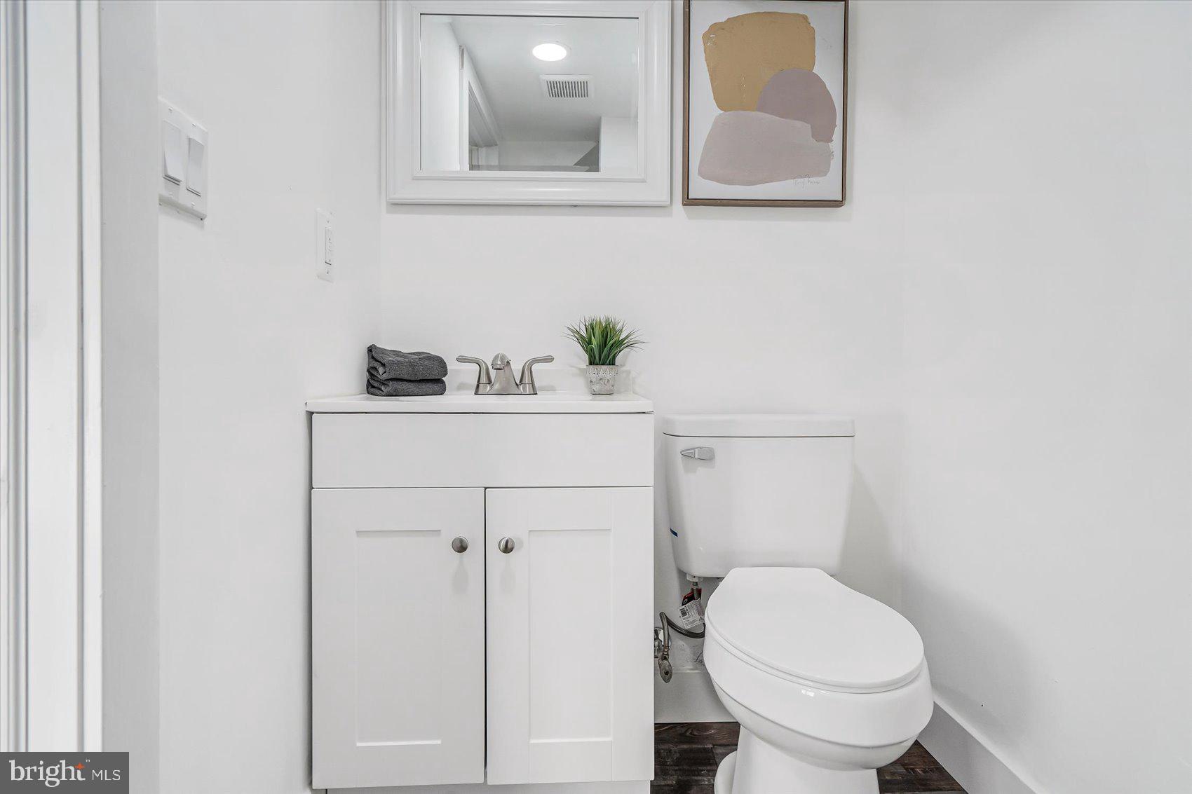 3925 Chesterfield Avenue Baltimore, MD 21213 - Photo 29 of 35 a bathroom with a sink toilet and vanity