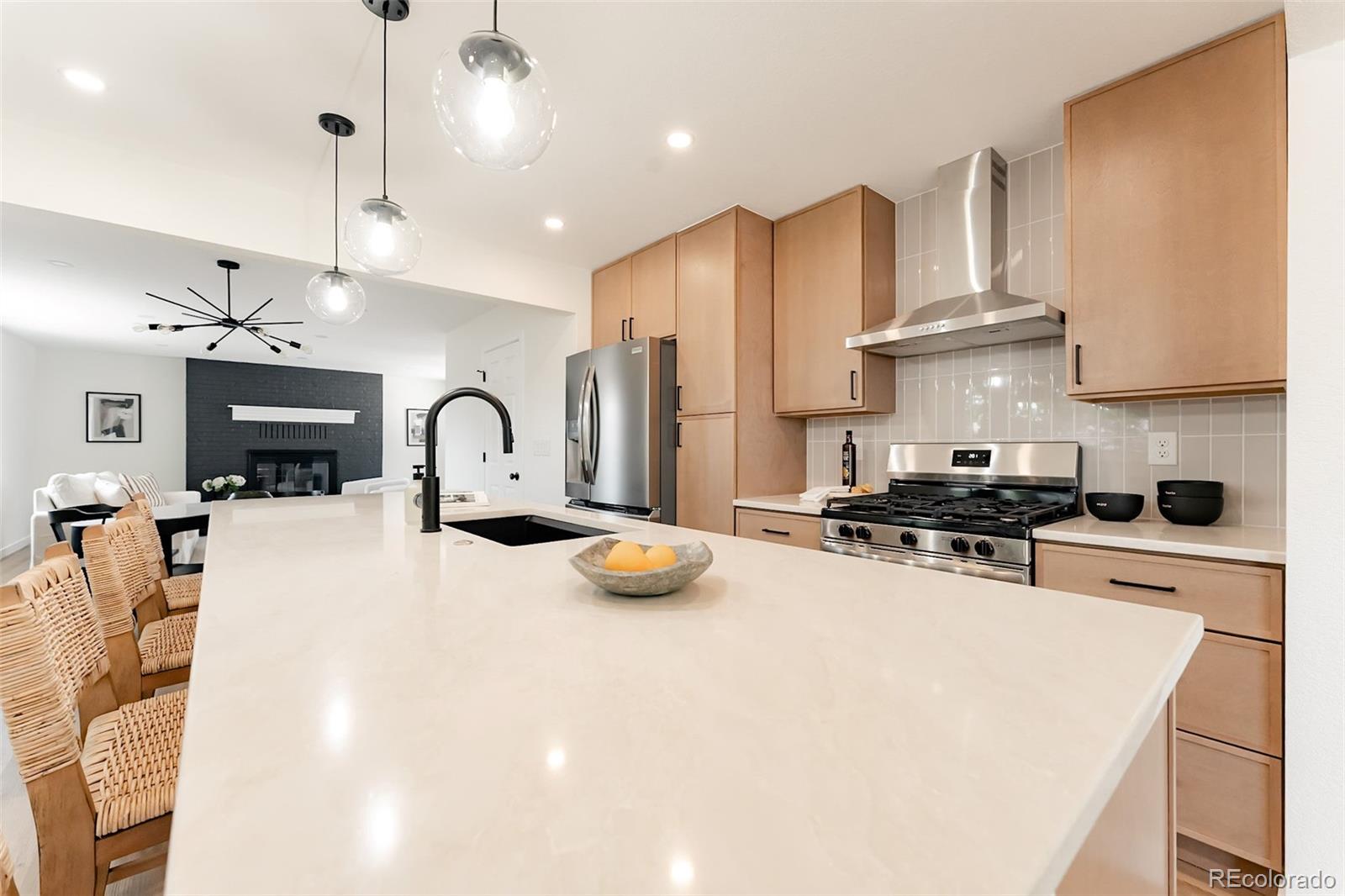 1279 South Raritan Street Denver, CO 80223 - Photo 1 of 25 a kitchen with stainless steel appliances granite countertop a sink a stove and a refrigerator