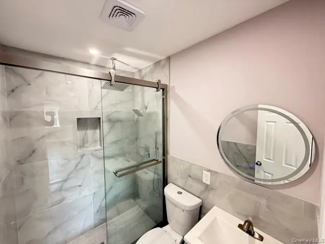 a bathroom with a toilet and a shower