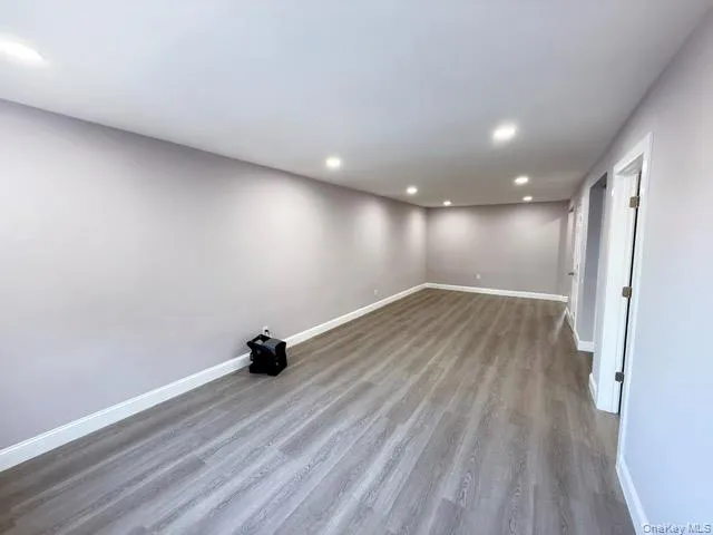 a view of a room with wooden floor