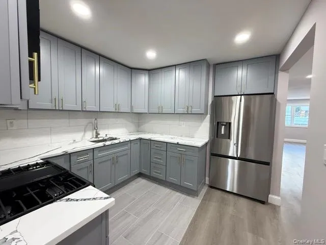 a kitchen with wooden cabinets and stainless steel appliances