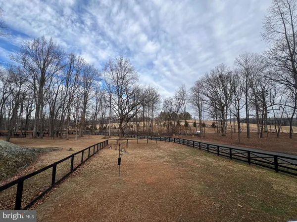 a view of a yard with wooden fence