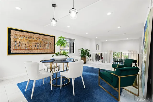 a view of a a dining room with furniture window and wooden floor