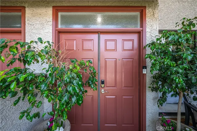 a view of a house with a small yard and plants