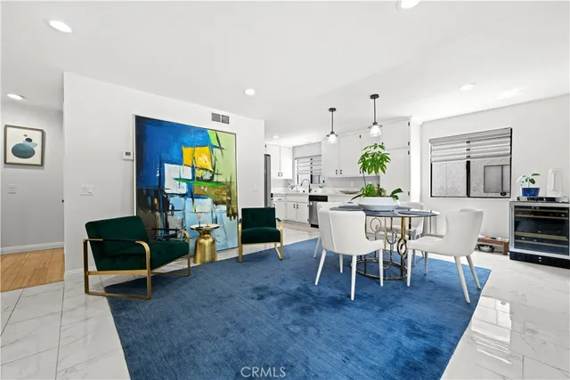 a dining room with furniture and wooden floor