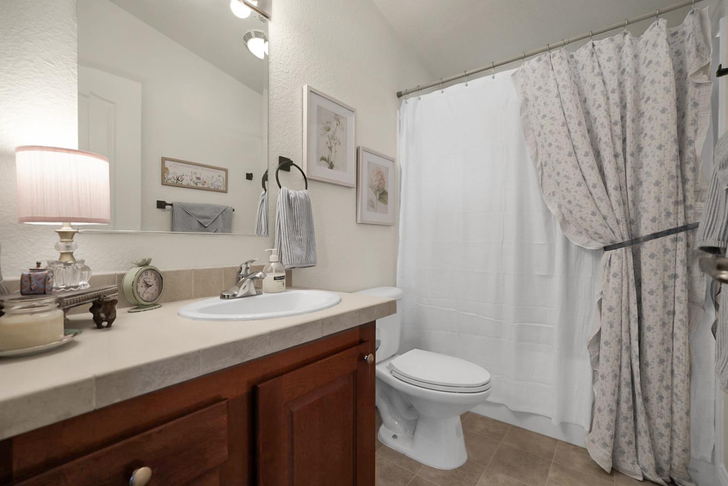 1459 Standiford, Unit 92 Modesto, CA 95350 - Photo 5 of 19 a bathroom with a toilet a sink and a mirror