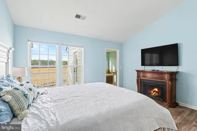 a bedroom with a large bed and a flat screen tv