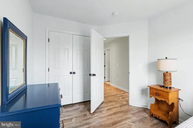 a view of room with wooden floor windows and entryway