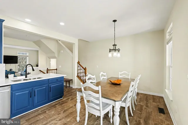 a dining room with a sink and chairs