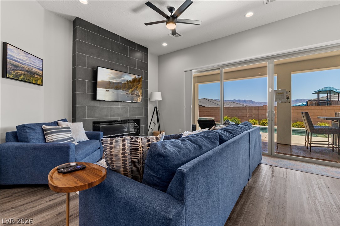 1436 Manassas Ridge Mesquite, NV 89027 - Photo 19 of 77 A spacious living area with sliding glass doors opening to a backyard with pool and distant mountain views.
