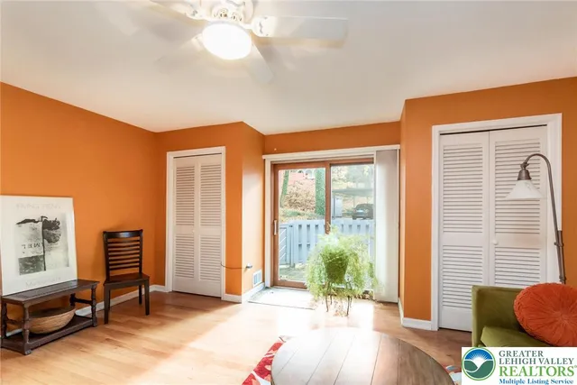 a view of a workspace with furniture and a bookshelf