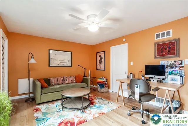 a living room with furniture a window and a clock