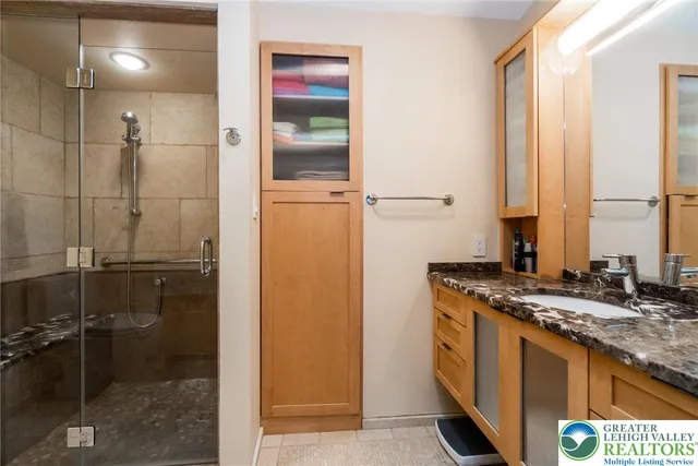 a spacious bedroom with a bed couch and a large window