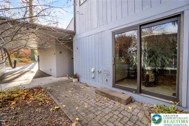 a living room with furniture a lamp and a large window