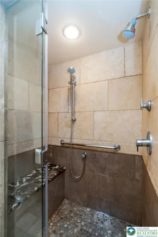 a bedroom with a bed and a large mirror on the dresser