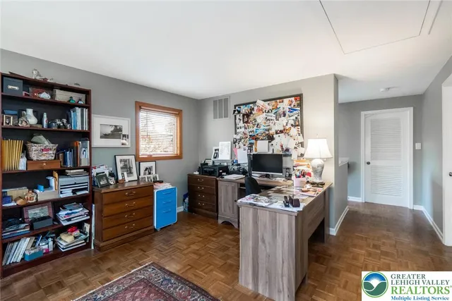 a living room with furniture a flat screen tv and a floor to ceiling window